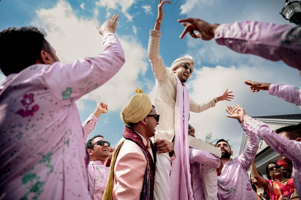 a candid moment of groom enjoying baraat celebration
