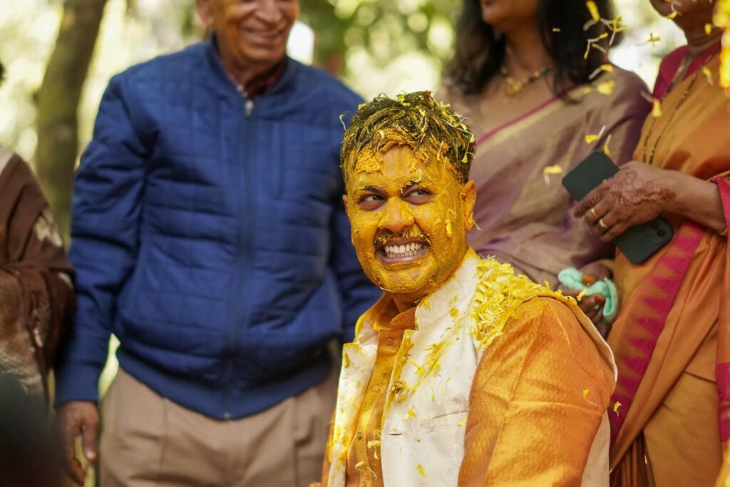 groom getting marinated in haldi before the wedding at Taj resort and spa, corbett