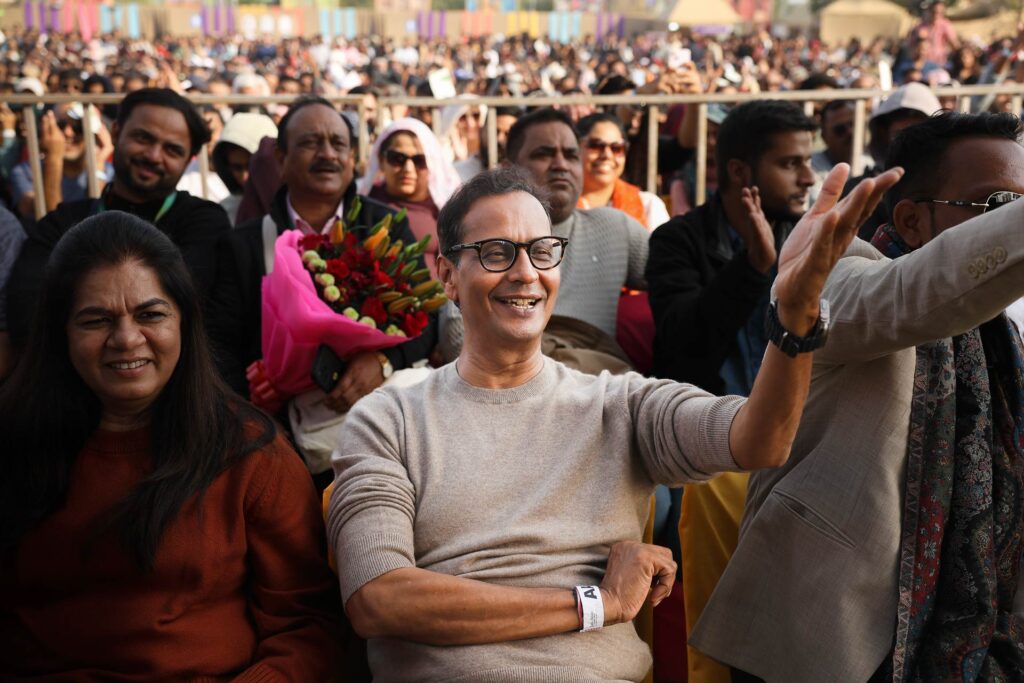 Candid emotion of audience members enjoying Jashn-e-Rekhta cultural event.