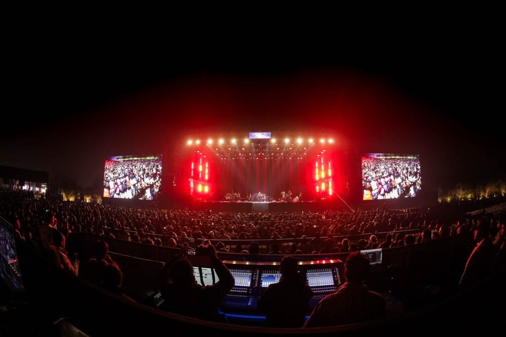 Wide view of the illuminated main stage and audience during an evening performance at Jashn-e-Rekhta cultural festival in Delhi.