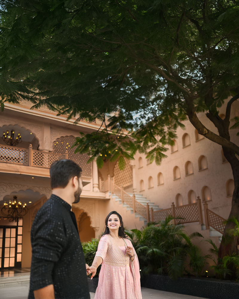 Couple posing during a pre wedding studio photoshoot in Faridabad with elegant indoor lighting and premium backdrop