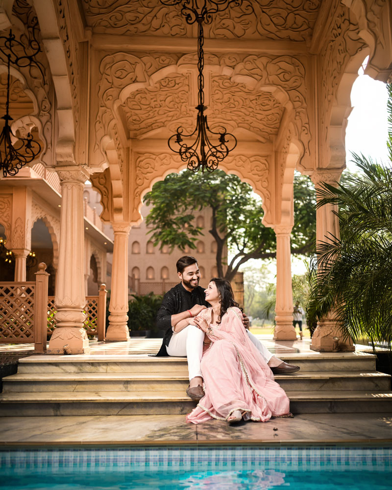 Happy couple smiling during candid pre wedding photography at a studio location in Faridabad
