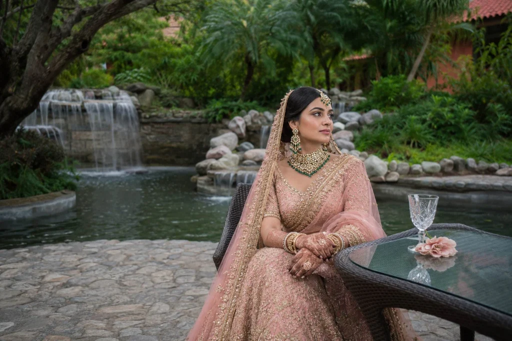 Bridal portrait beside the cobblestone waterfall feature at Taj Corbett during daytime