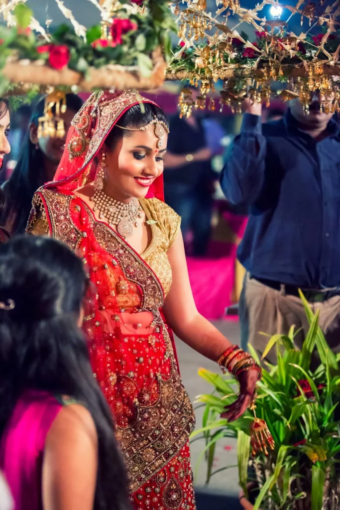 Bride entering under floral canopy during wedding ceremony