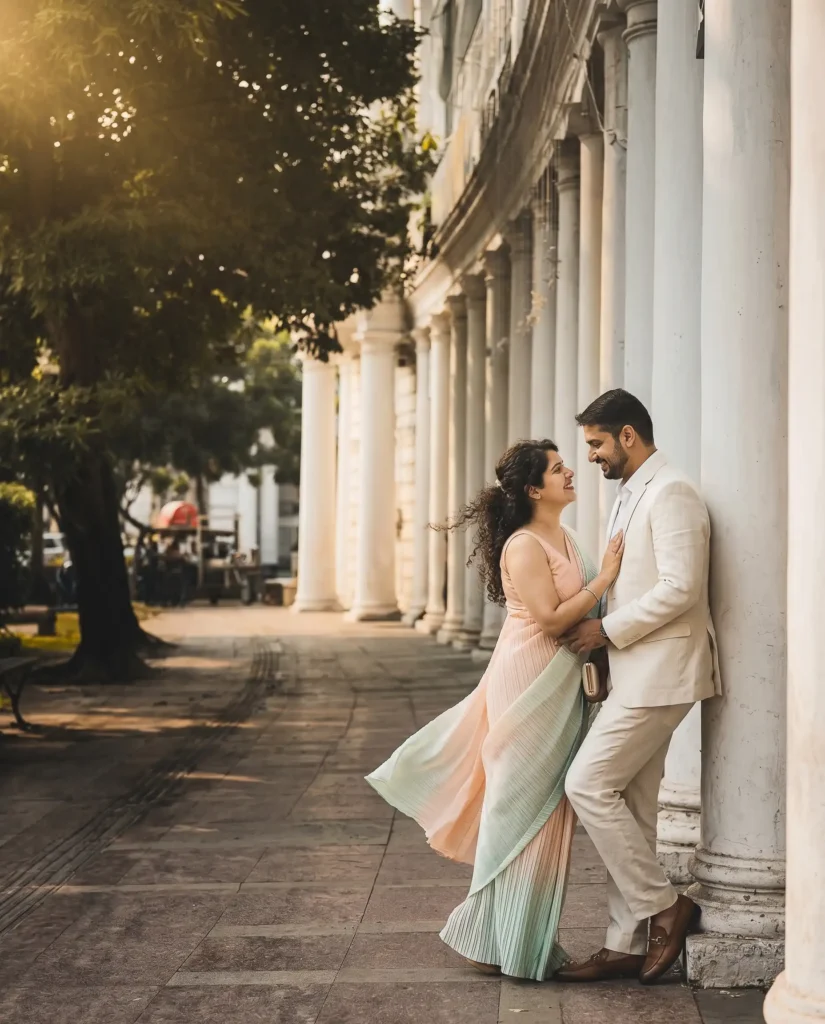 Romantic pre wedding couple portrait at Connaught Place Delhi with white colonial pillars and cinematic golden hour lighting