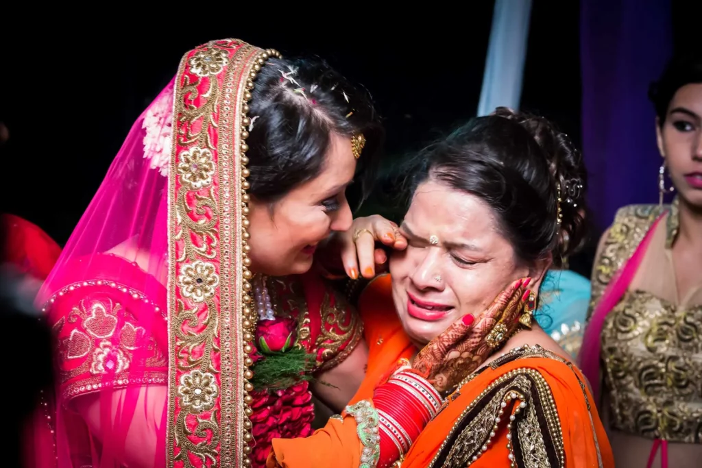 Emotional moment between bride and family during wedding