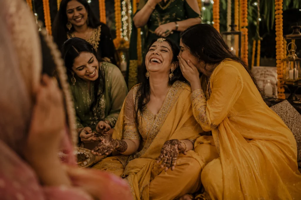 Bride laughing during mehendi ceremony at Muslim wedding in Aligarh