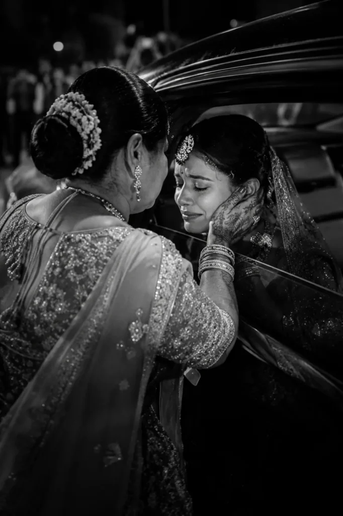 Emotional mother and daughter bidaai moment beside wedding car during Muslim wedding in Aligarh