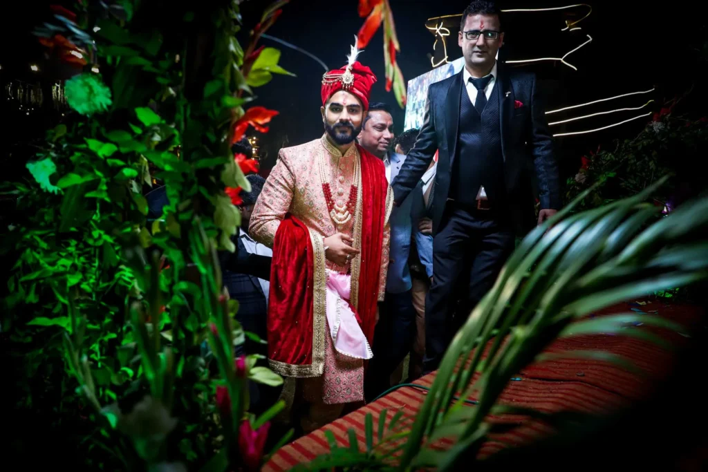 Groom making entry during baraat with lights and celebration