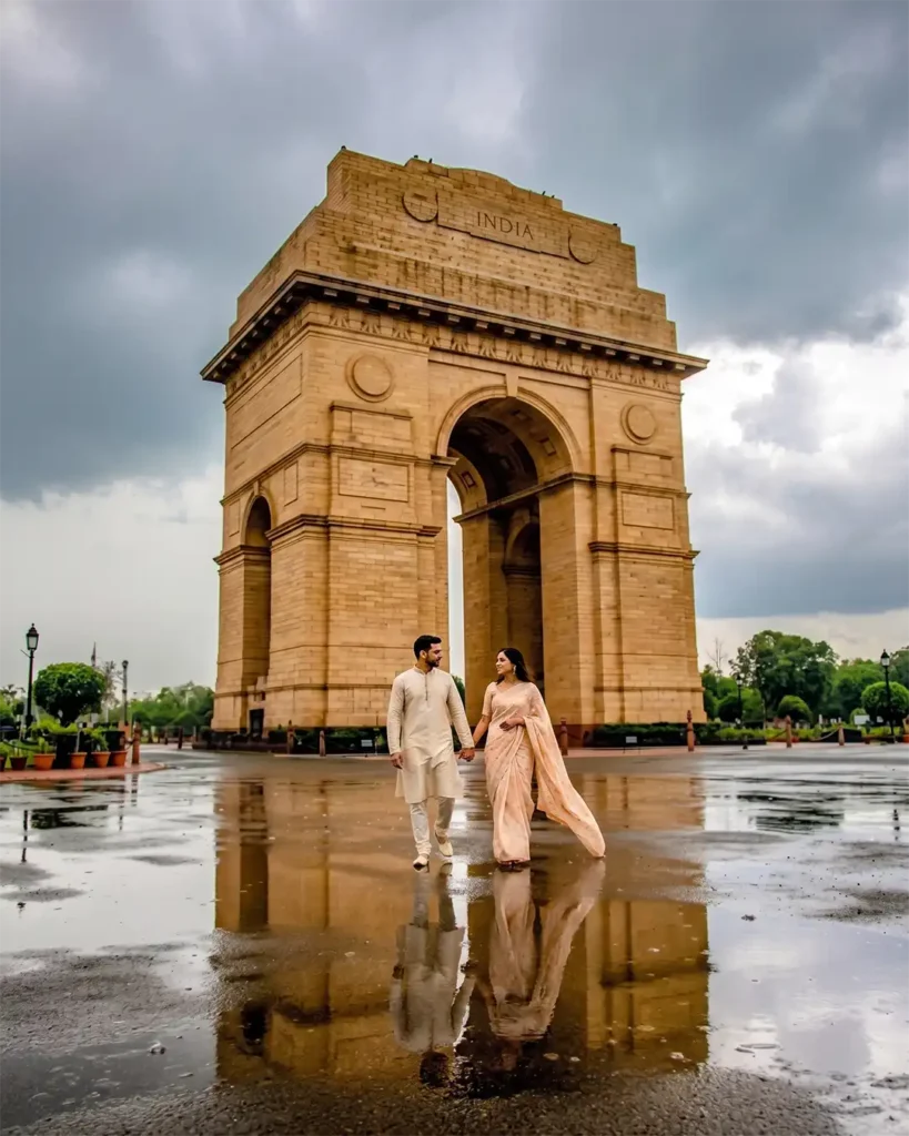 Couple in elegant Indian attire during a cinematic rainy evening pre wedding shoot at India Gate Delhi