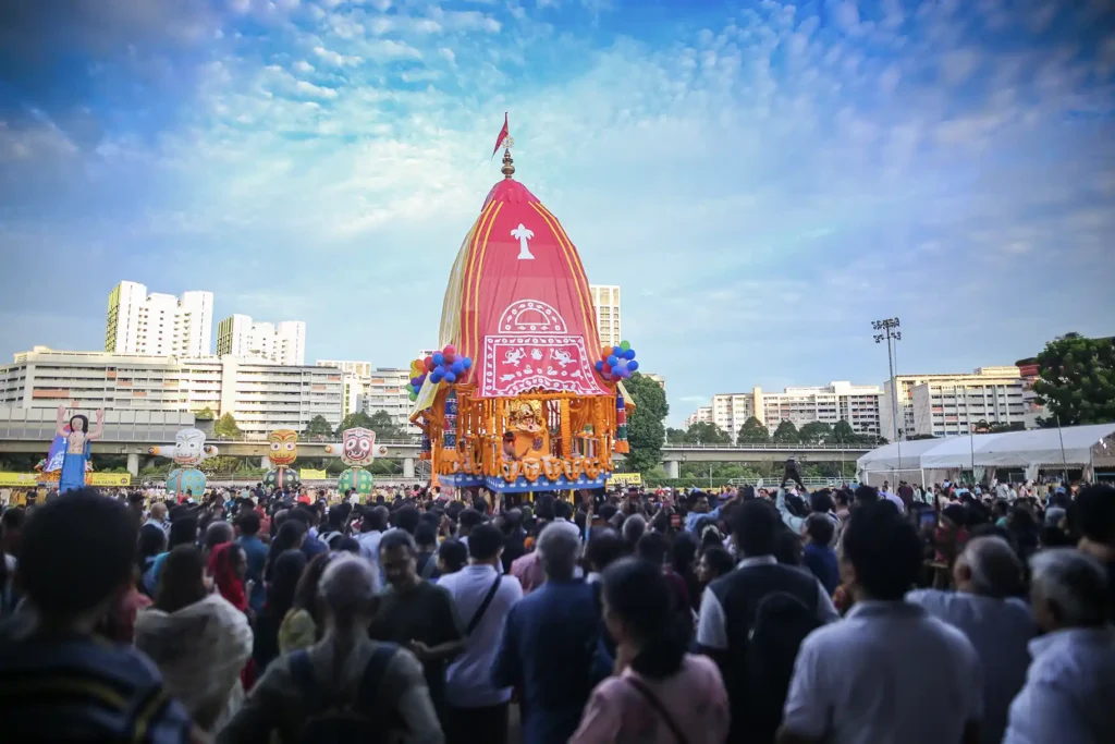 Devotees participate in the Jagannath Rath Yatra organised by International Sri Krishna Mandir Singapore at Woodlands Stadium, Singapore, in 2025.