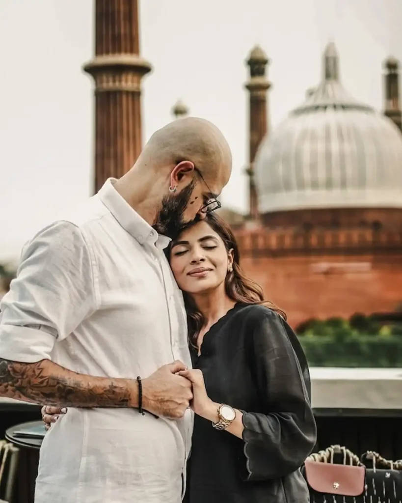 Couple sitting together during a rooftop pre wedding shoot near Jama Masjid in old Delhi