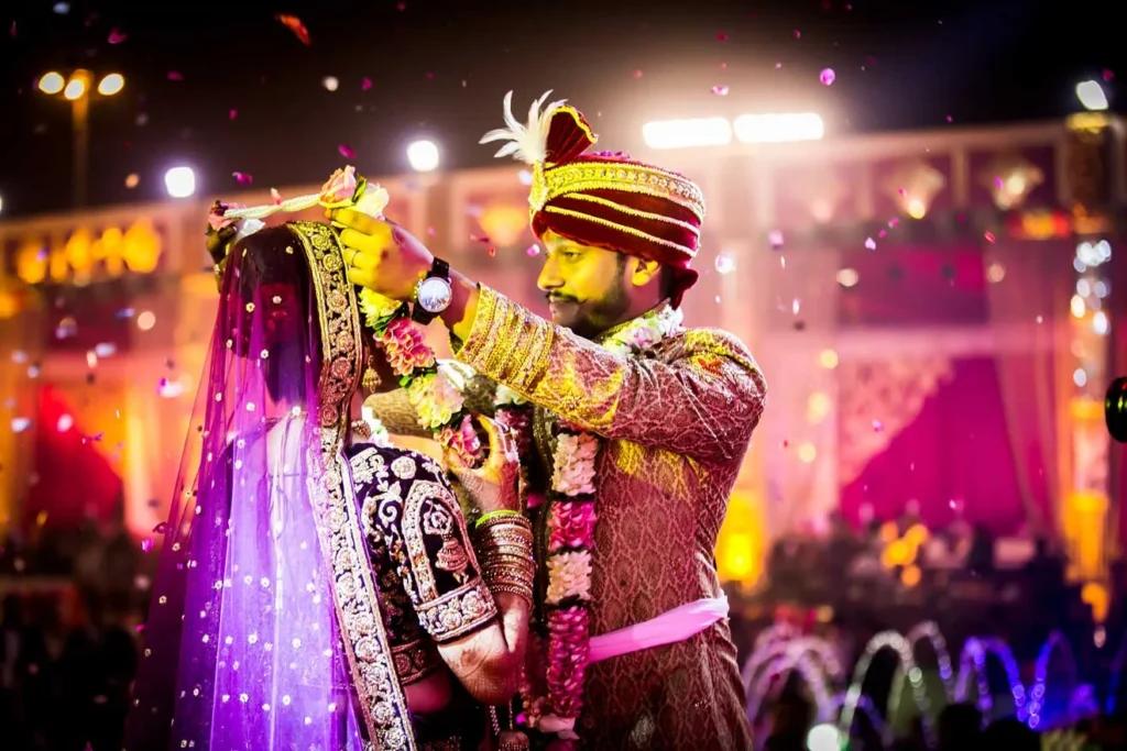 Couple exchanging garlands during wedding ceremony