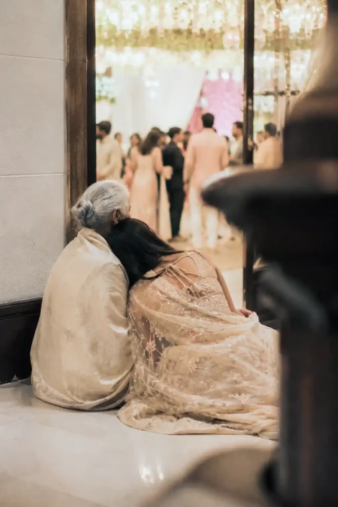 Family members sharing a quiet moment during an Indian wedding celebration