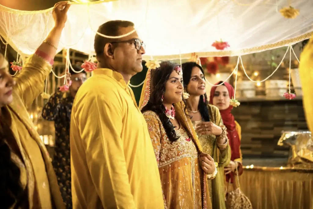 Family members walking down with Zobia and Qutub's intimate haldi and ubtan celebration at Fort Royale in Aligarh.
