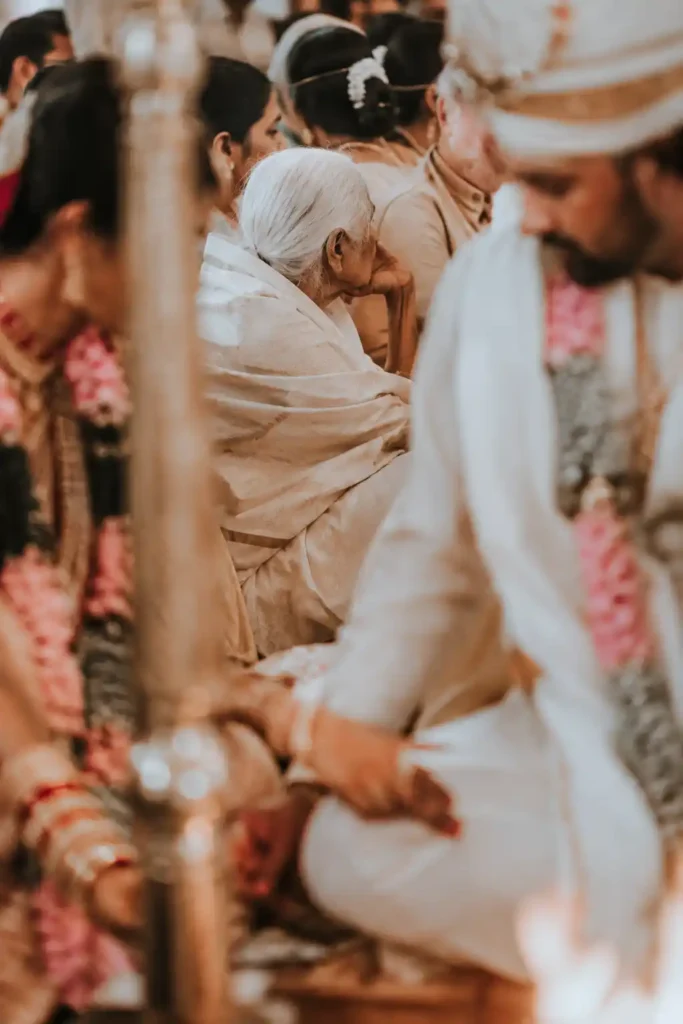 Grandparent quietly observing an Indian wedding ceremony