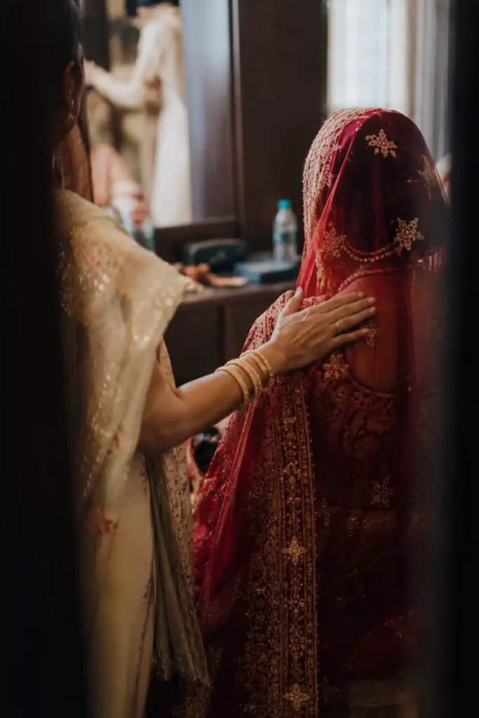 Family member comforting a bride before an Indian wedding ceremony