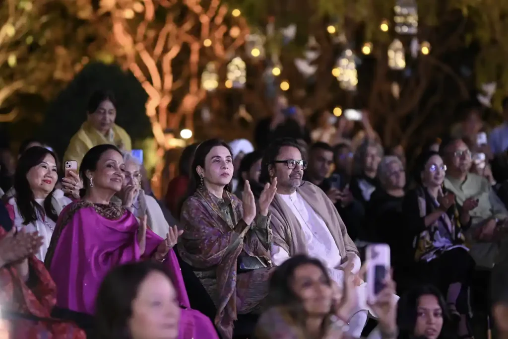 Audience members engaged with a live performance at Ragas by the River, experiencing Indian classical music in an intimate natural setting.