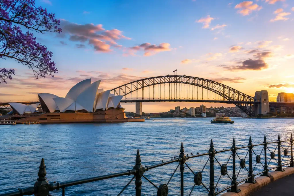 Sydney Harbour featuring the Sydney Opera House and Harbour Bridge at sunset, an iconic destination for luxury destination wedding photography.