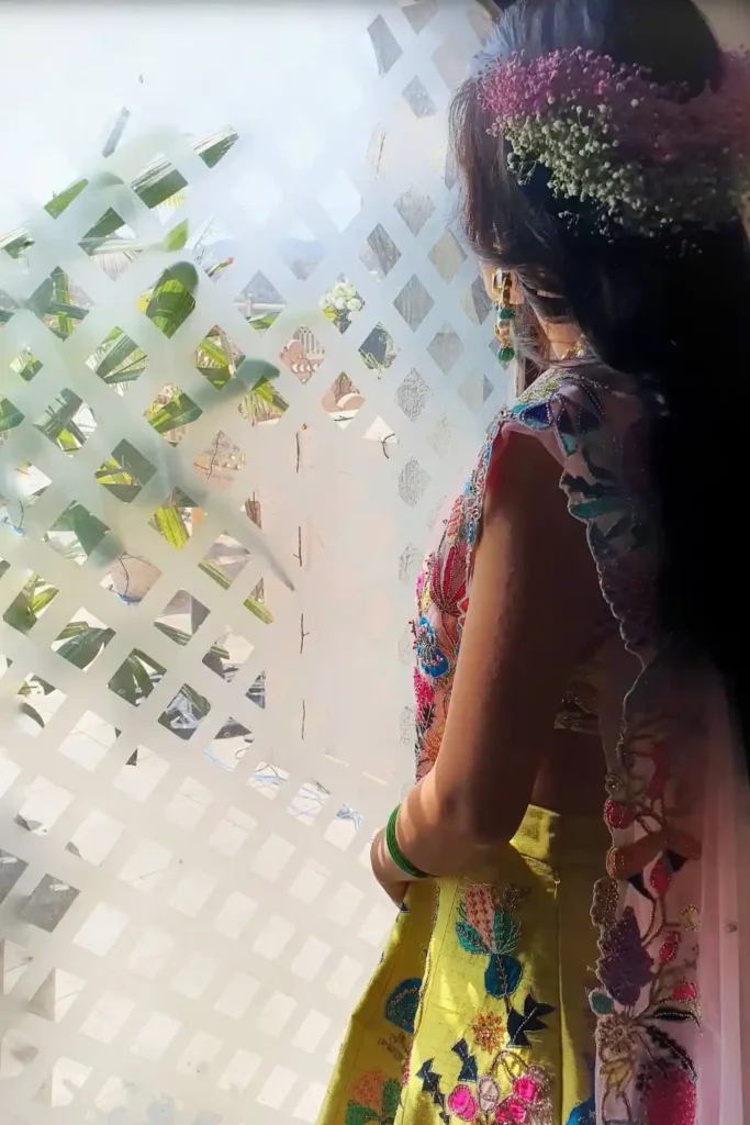 Bride illuminated by natural window light during a quiet pre wedding moment