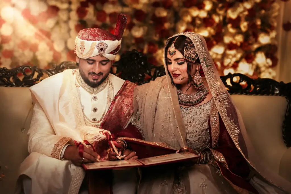 Bride and groom Zobia and Qutub signing the Nikahnama during their intimate wedding ceremony at Fort Royale in Aligarh.