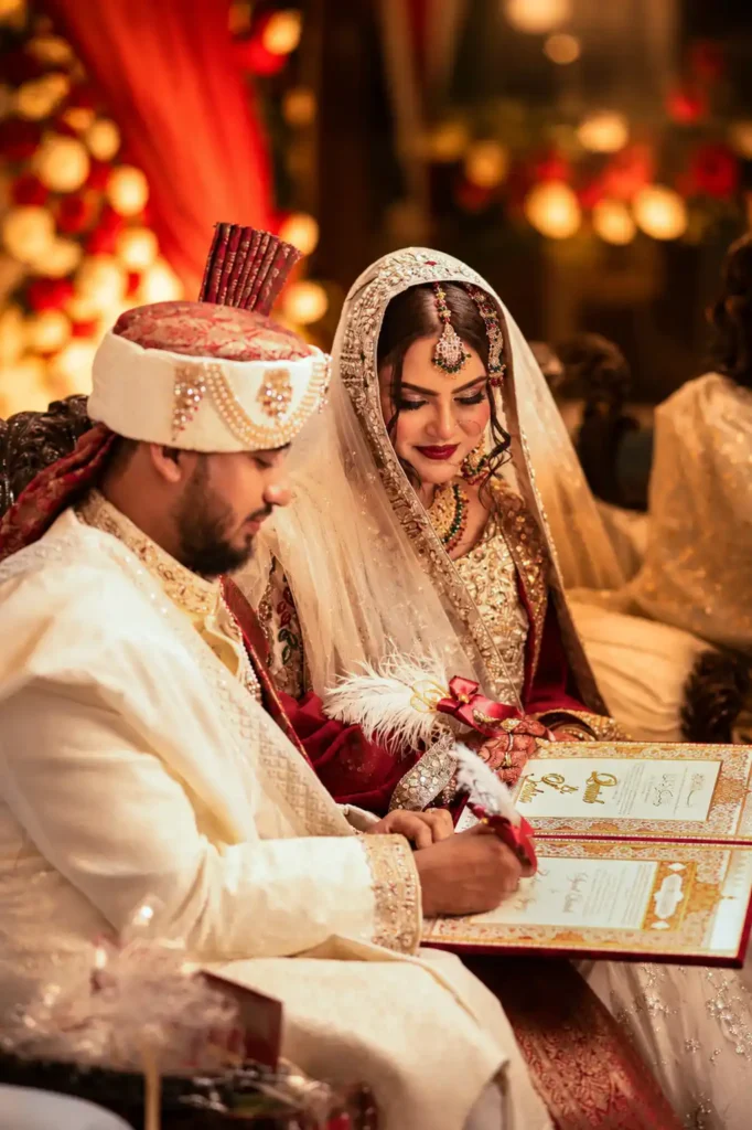 Bride Zobia and groom Qutub signing the Nikahnama during their Nikah ceremony at Fort Royale in Aligarh.